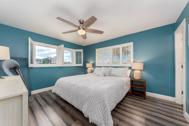 bedroom with dark hardwood / wood-style floors and ceiling fan