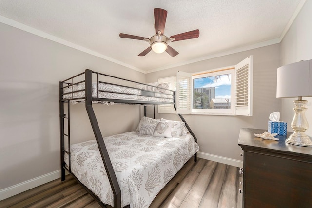 bedroom featuring ceiling fan, a textured ceiling, ornamental molding, and dark hardwood / wood-style flooring