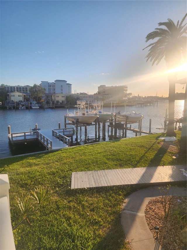 dock area with a yard and a water view