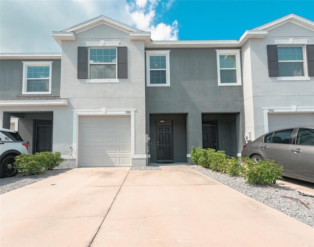 townhome / multi-family property featuring a garage