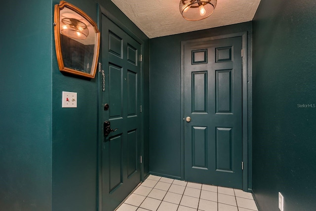 interior space featuring a textured ceiling and light tile patterned flooring