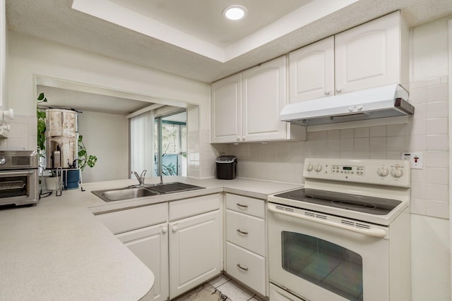 kitchen featuring white cabinets, backsplash, white electric range oven, and sink