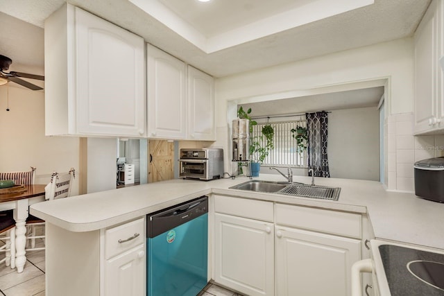 kitchen featuring white cabinets, dishwasher, kitchen peninsula, and sink