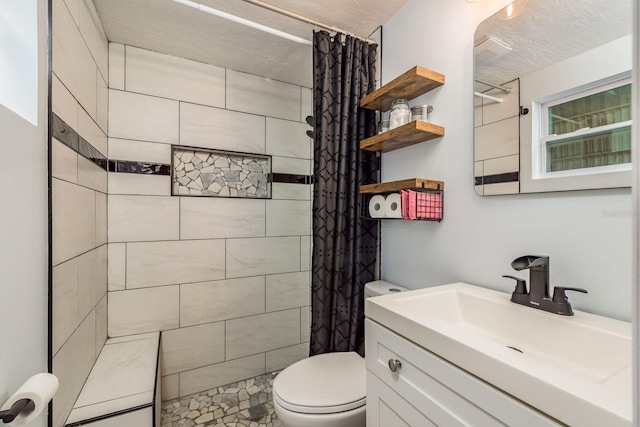 bathroom with vanity, toilet, a textured ceiling, and curtained shower