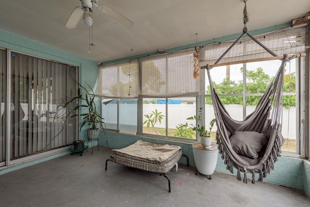 sunroom / solarium with a wealth of natural light and ceiling fan