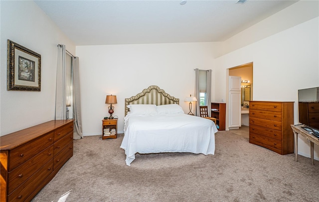 bedroom with light carpet and ensuite bathroom