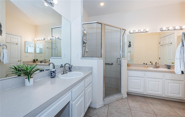 bathroom featuring tile patterned flooring, an enclosed shower, and vanity