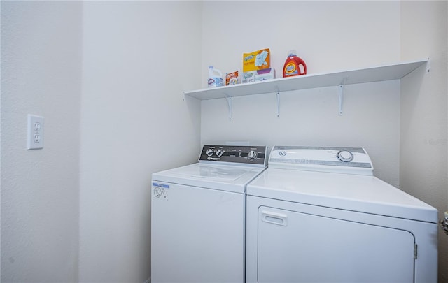 clothes washing area featuring washing machine and dryer