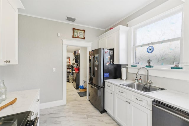 kitchen featuring light stone counters, white cabinets, sink, appliances with stainless steel finishes, and crown molding