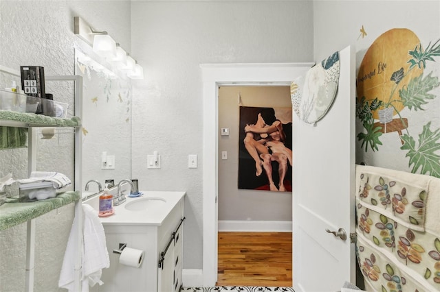 bathroom featuring vanity and hardwood / wood-style flooring