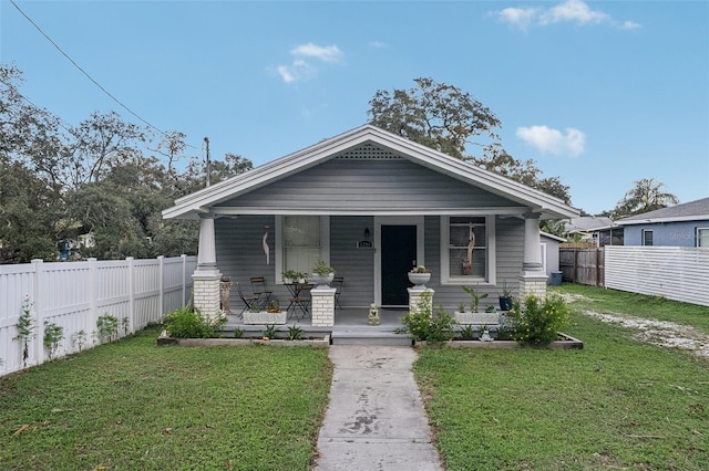 bungalow-style house with a front yard and a porch