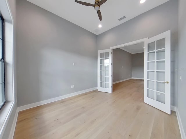 spare room with french doors, light wood-type flooring, and ceiling fan