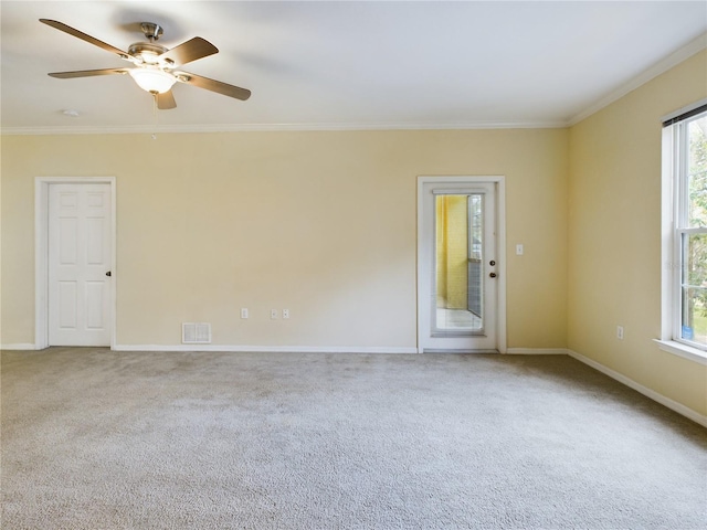 carpeted spare room featuring ceiling fan and ornamental molding