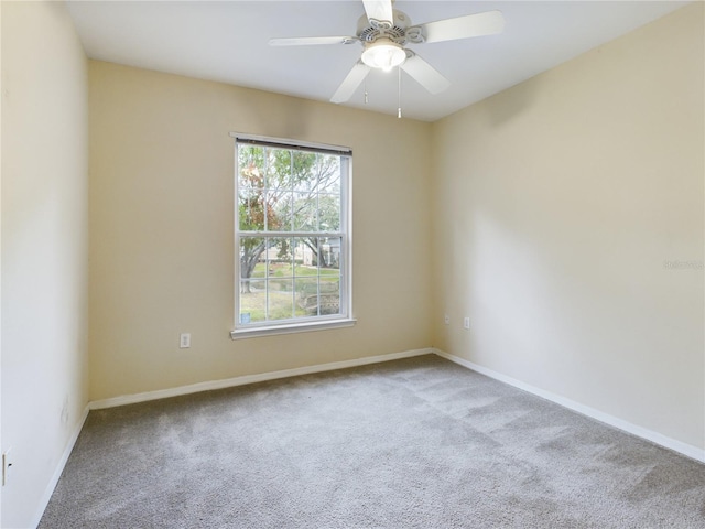 spare room featuring light colored carpet and ceiling fan