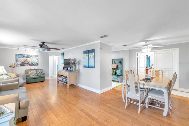 dining area with light hardwood / wood-style floors, crown molding, and ceiling fan