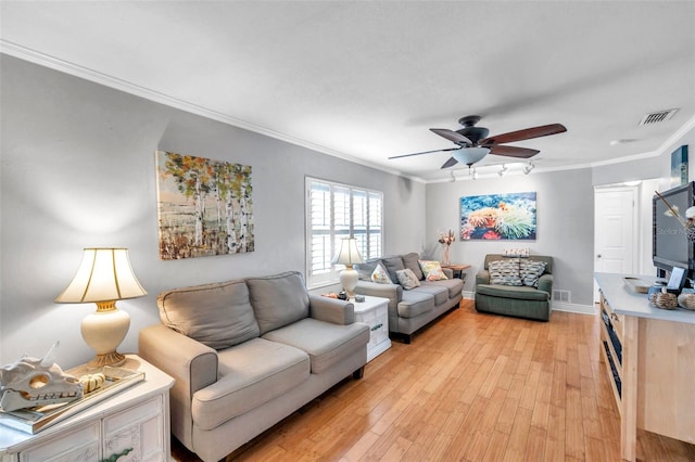 living room featuring ornamental molding, light wood-type flooring, and ceiling fan