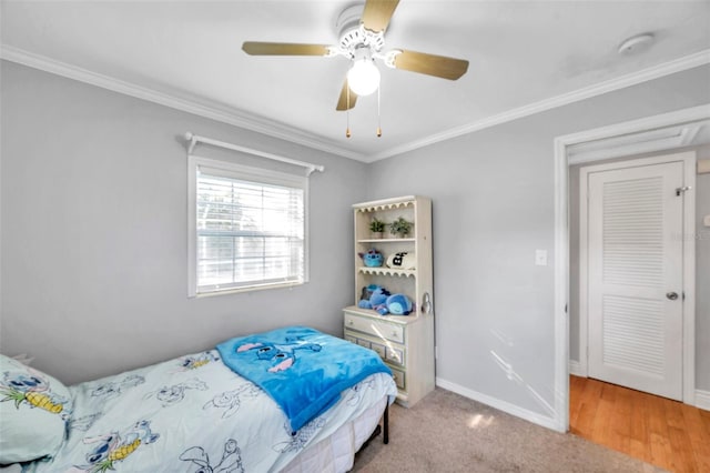 carpeted bedroom featuring ornamental molding and ceiling fan