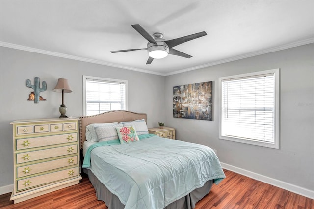 bedroom featuring crown molding, dark hardwood / wood-style floors, and ceiling fan