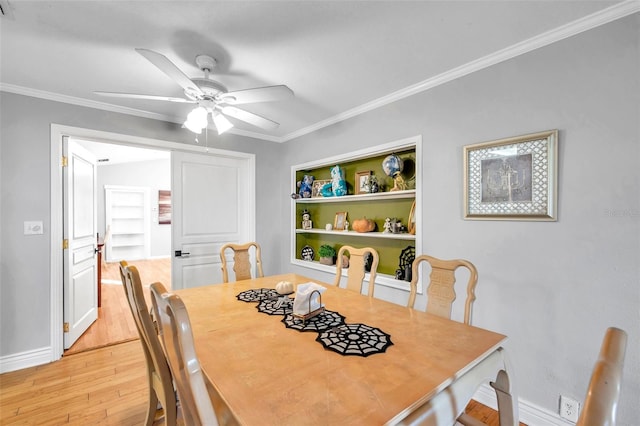 dining area with ornamental molding, light wood-type flooring, and ceiling fan