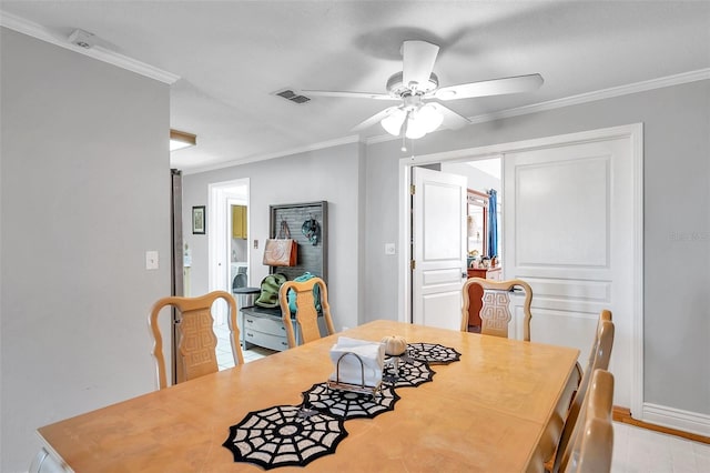 dining space with ceiling fan and crown molding