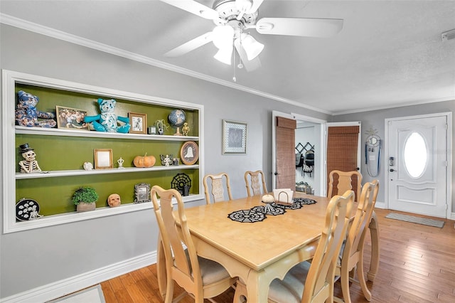 dining room featuring light hardwood / wood-style flooring, crown molding, and ceiling fan