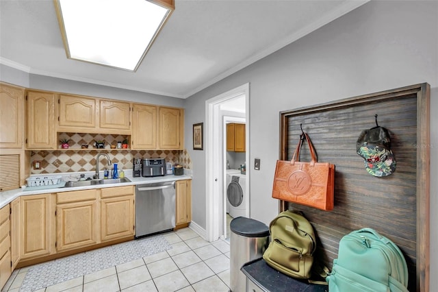 kitchen with stainless steel dishwasher, sink, light tile patterned flooring, and washer / clothes dryer