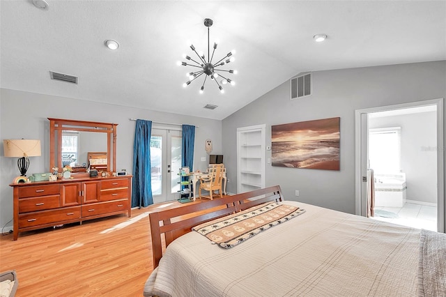 bedroom featuring lofted ceiling, a chandelier, connected bathroom, and light wood-type flooring