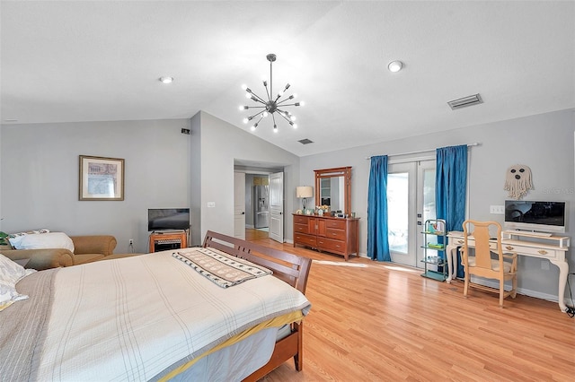 bedroom featuring access to outside, french doors, light hardwood / wood-style floors, vaulted ceiling, and a notable chandelier