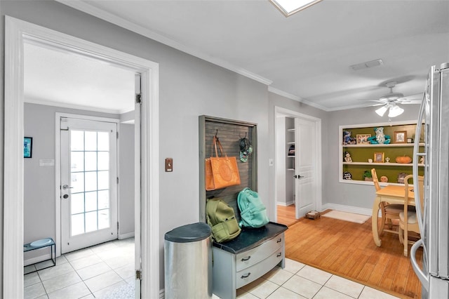 interior space featuring ceiling fan, crown molding, light wood-type flooring, and stainless steel fridge