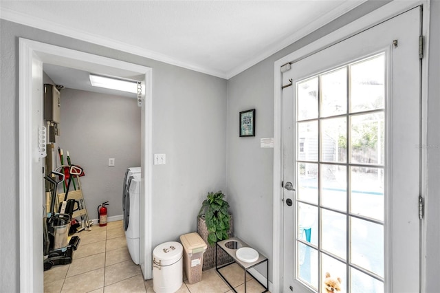 entryway featuring washer / dryer, crown molding, water heater, and light tile patterned flooring