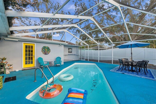 view of swimming pool with a patio area and a lanai