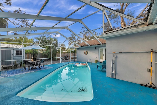 view of swimming pool with a patio area and glass enclosure