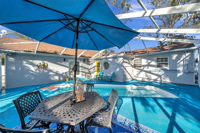 view of swimming pool with a patio and a lanai