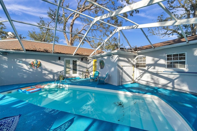 view of swimming pool with a patio and a lanai