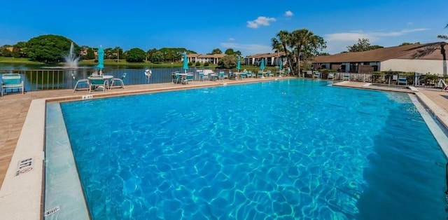 view of pool featuring a water view