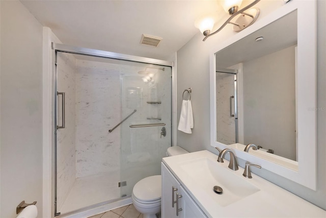 bathroom with toilet, vanity, tile patterned flooring, and walk in shower