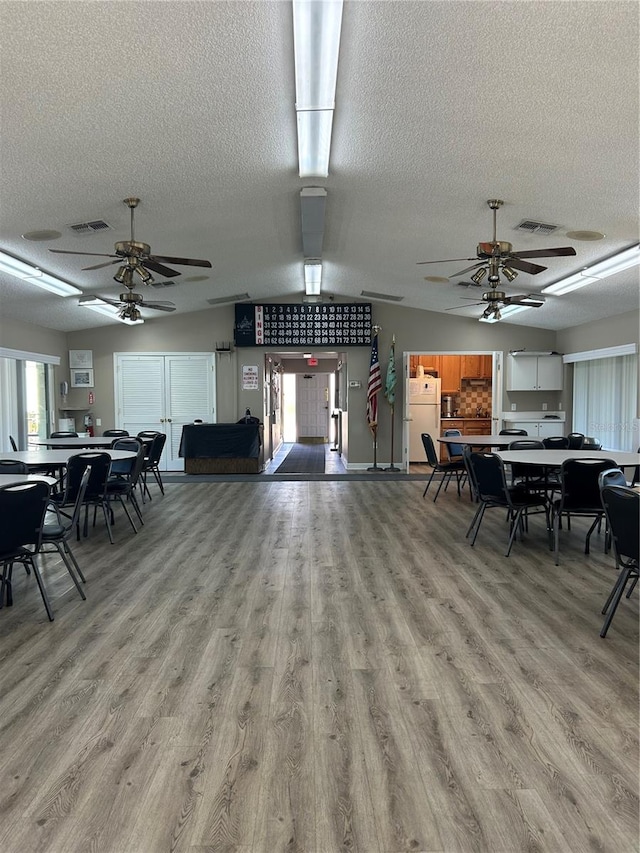 dining room with a textured ceiling and light hardwood / wood-style flooring