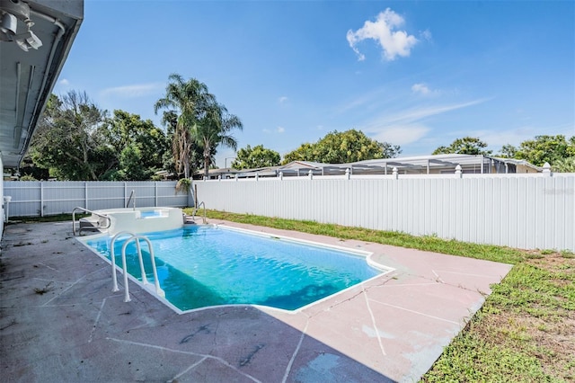 view of swimming pool featuring a patio area