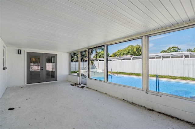 unfurnished sunroom with french doors