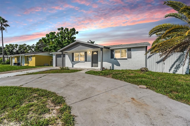 ranch-style home with a yard