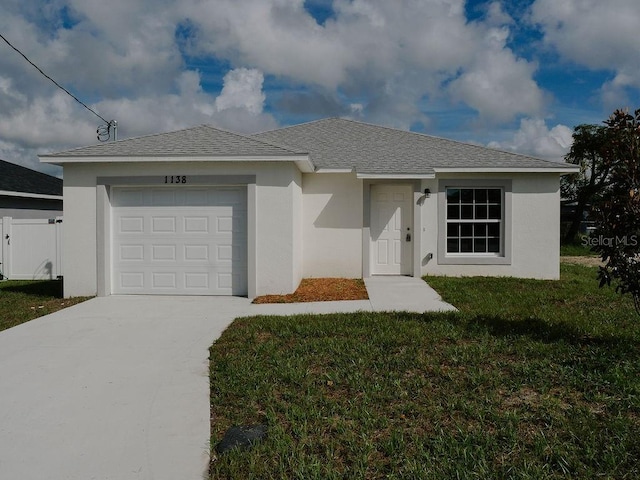 ranch-style home with a garage and a front lawn