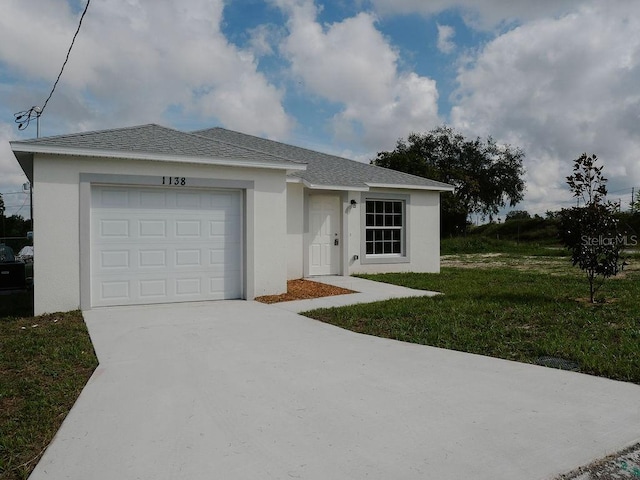 ranch-style home with a garage and a front lawn