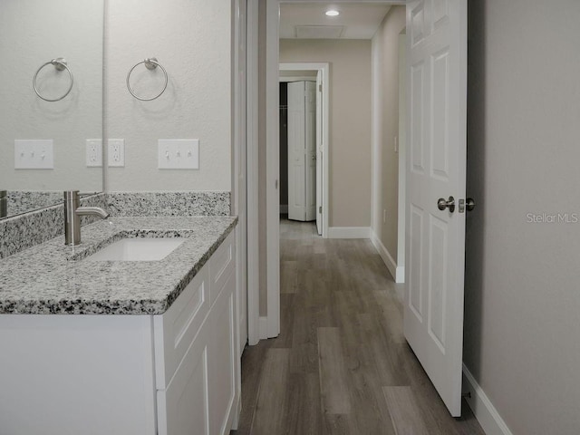 bathroom with vanity and hardwood / wood-style flooring