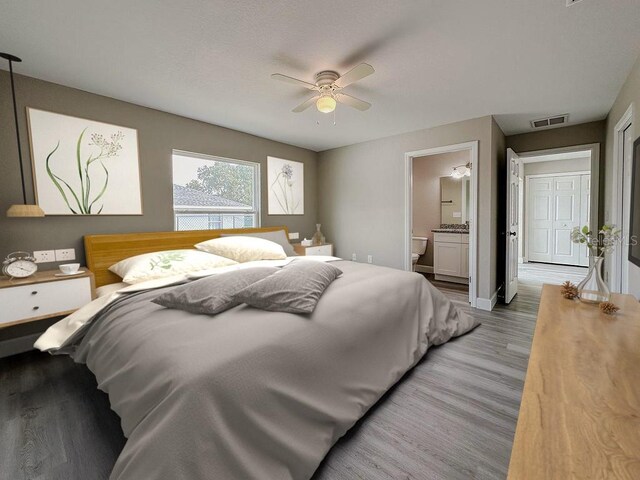 bedroom featuring ensuite bathroom, light hardwood / wood-style flooring, and ceiling fan