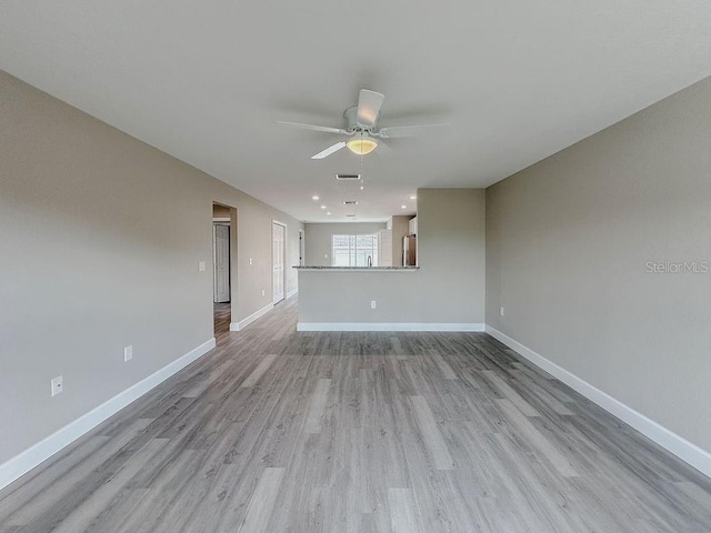 unfurnished living room with ceiling fan and light hardwood / wood-style flooring