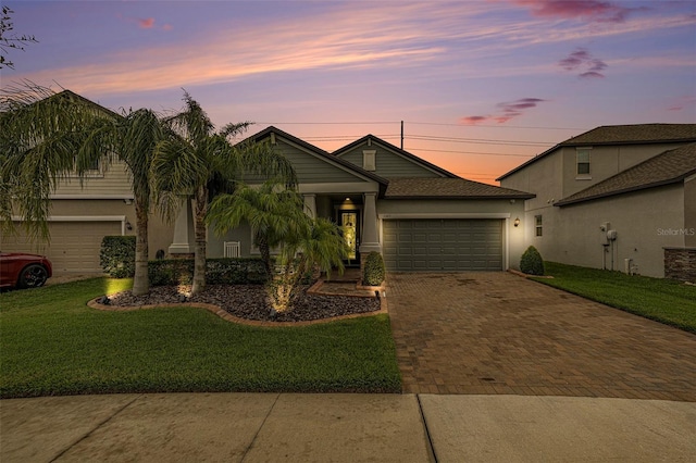 view of front of house with a yard and a garage