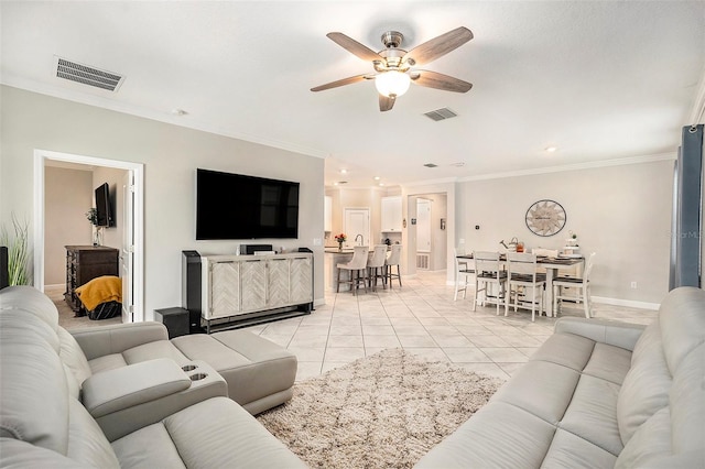 tiled living room with ceiling fan and crown molding