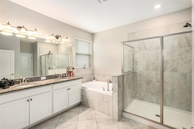 bathroom with shower with separate bathtub, vanity, and tile patterned floors