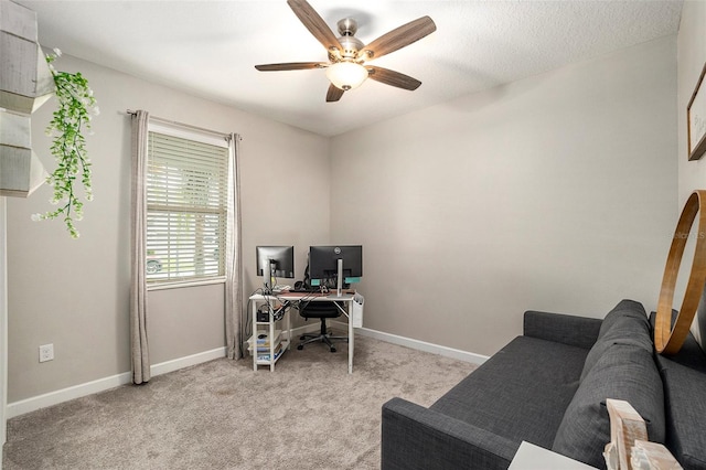 carpeted home office featuring ceiling fan