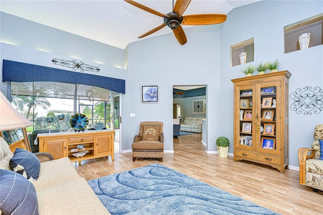 living room with ceiling fan and light hardwood / wood-style flooring